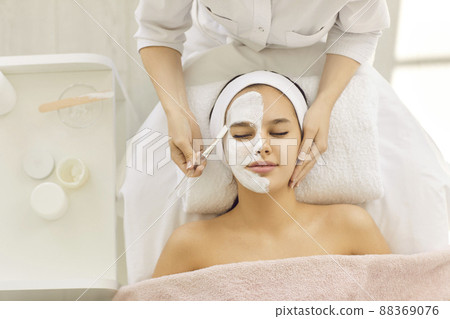 Satisfied young beautiful woman uses services of professional beautician in beauty salon or spa. Satisfied young beautiful woman uses services of professional beautician in beauty salon or spa. 88369076