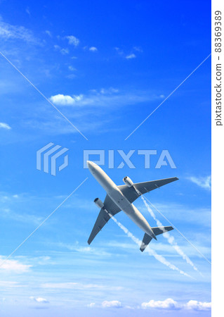 Vertical nature background with aircraft and Jet trailing smoke in the sky. Airplane and condensation trail 88369389
