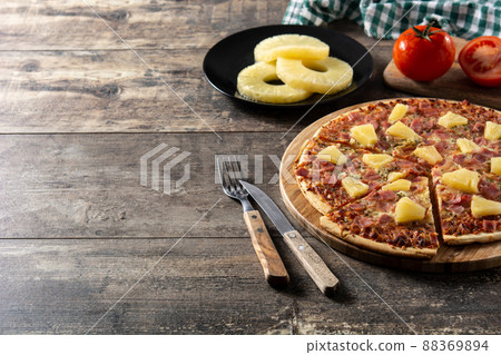 Hawaiian pizza with pineapple,ham and cheese Hawaiian pizza with pineapple,ham and cheese 88369894