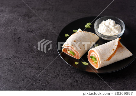 Salmon wrap sandwich roll with cheese and vegetables 88369897