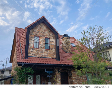 Brick Western-style building with red roof dormer 88370097