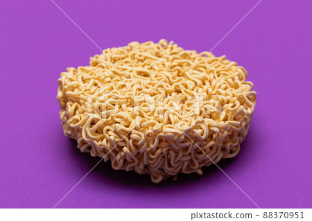 Uncooked Instant Noodles on Violet Background Uncooked Instant Noodles on Violet Background 88370951