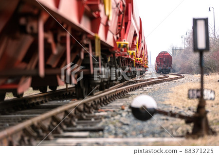 Train wagons carrying freight containers for shipping companies. distribution and freight transport by a railway, transport concept Train wagons carrying freight containers for shipping companies. distribution and freight transport by a railway, transport concept 88371225