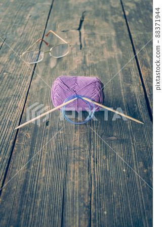 Yarn balls, knitting needles and glasses Yarn balls, knitting needles and glasses 88371944