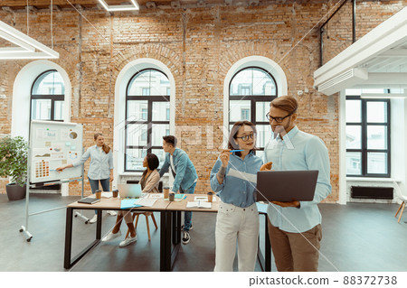 Young woman amd man checking teamwork. Colleague motivation for success. 88372738