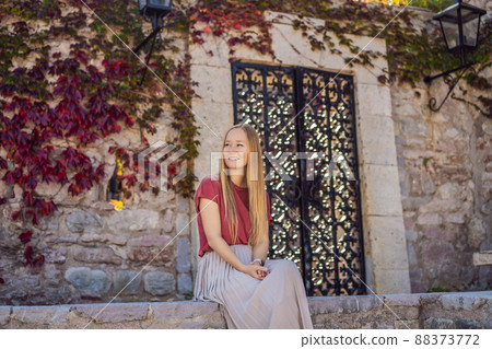 Woman tourist on background of beautiful view of the island of St. Stephen, Sveti Stefan on the Budva Riviera, Budva, Montenegro. Travel to Montenegro concept 88373772