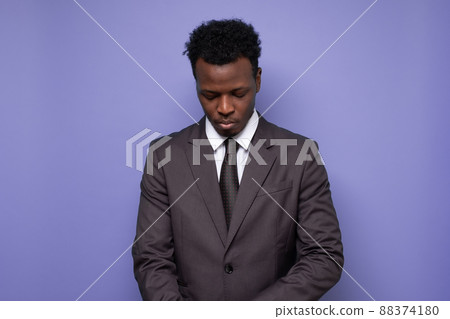 sad african businessman being tired or exhausted looking down. 88374180