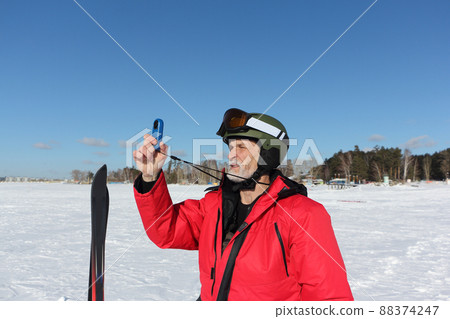 Man measures wind speed with an anemometer Man measures wind speed with an anemometer 88374247