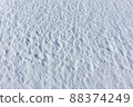 Relief snow surface of a frozen river in winter 88374249