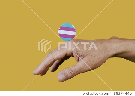 hand and pin button with transgender pride flag 88374449