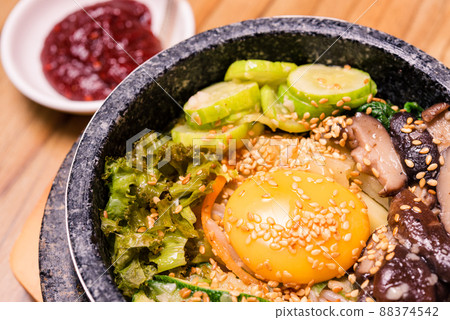 Korean traditional dish- bibimbap mixed rice with vegetables Include beef and fried egg 88374542