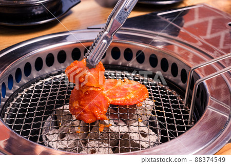 Grilling meat pork Korean BBQ traditional style on stove serve in restaurant Grilling meat pork Korean BBQ traditional style on stove serve in restaurant 88374549