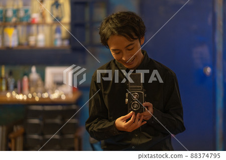 A smiling photographer with a classic camera 88374795