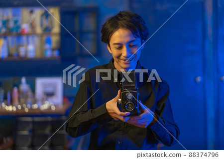 A smiling photographer with a classic camera A smiling photographer with a classic camera 88374796