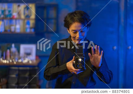 A smiling photographer with a classic camera A smiling photographer with a classic camera 88374801