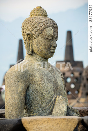 Side portrait of buddha statue at buddhist temple Borobudur, Java, Indonesia 88377925