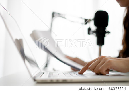 Happy Asian woman setting up a living room in her house for podcast studio, woman arranging a podcast and online radio station at home. Professional young podcaster speaking through a microphone. Happy Asian woman setting up a living room in her house for podcast studio, woman arranging a podcast and online radio station at home. Professional young podcaster speaking through a microphone. 88378524