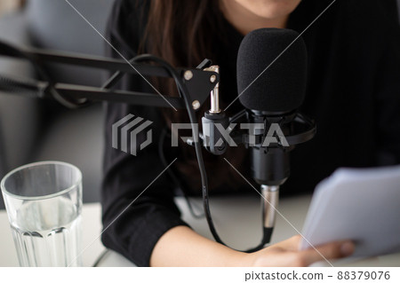 Beautiful and good looking young Asian woman arranging home podcast channel. Businesswoman recording her podcast for her online podcast live on the laptop computer and tablet. Modern working lifestyle 88379076