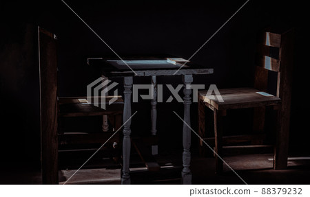 Two wooden chairs and old wooden white table standing front of green cement wall. Two wooden chairs and old wooden white table standing front of green cement wall. 88379232