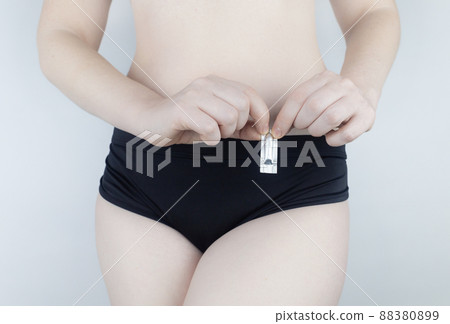 Vaginal or rectal candle in the hands of a woman against the background of the abdomen and underwear. Treatment vaginal infections, candidiasis, thrush and sexually transmitted infections Vaginal or rectal candle in the hands of a woman against the background of the abdomen and underwear. Treatment vaginal infections, candidiasis, thrush and sexually transmitted infections 88380899