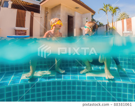 Kids having fun playing underwater in swimming pool on summer vacation Kids having fun playing underwater in swimming pool on summer vacation 88381061