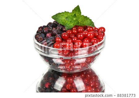 Berries of amelanchier and red currant on glass bowl. 88381773
