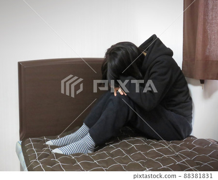 A woman depressed on the bed in her room 88381831