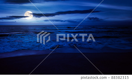 calm sea scenery at night. waves wash empty sandy beach in full moon light. relax and summer vacation concept. warm velvet season weather with clouds on the sky calm sea scenery at night. waves wash empty sandy beach in full moon light. relax and summer vacation concept. warm velvet season weather with clouds on the sky 88382315