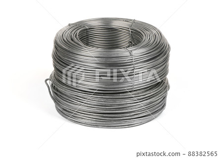 Two coils of galvanized wires lying on white background. Two coils of galvanized wires lying on white background. 88382565