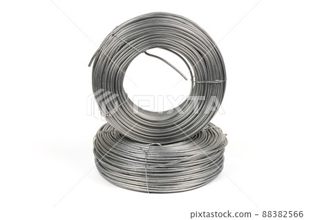 Two coils of galvanized wires lying on white background. Two coils of galvanized wires lying on white background. 88382566
