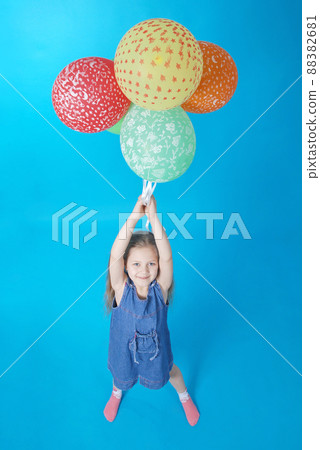 Girl holds balloons Girl holds balloons 88382681