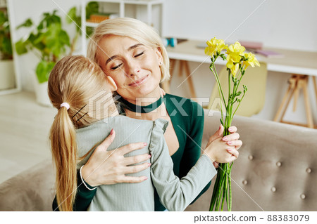 Girl Embracing Mom on Mothers Day 88383079