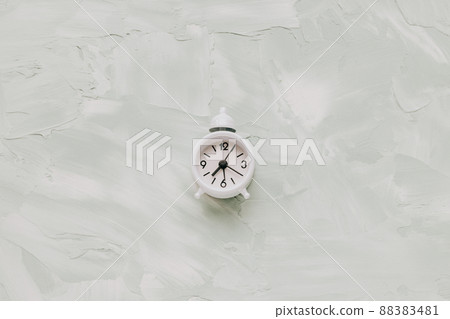 Small vintage alarm clock with bell on green background. Morning routine Small vintage alarm clock with bell on green background. Morning routine 88383481