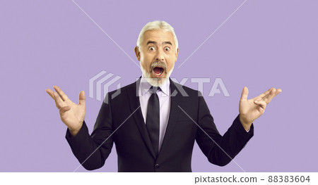 Senior businessman says WOW and looks at camera with funny surprised face expression 88383604