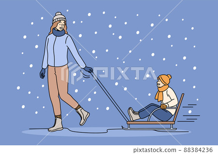 Happy mom ride son on sled outdoors Happy mom ride son on sled outdoors 88384236