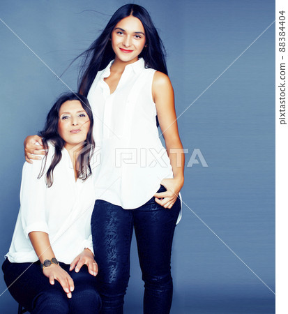 cute pretty teen daughter with mature mother hugging, fashion style brunette, lifestyle people concept 88384404