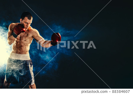 Sportsman boxer fighting on black background. Copy Space. Boxing sport concept Sportsman boxer fighting on black background. Copy Space. Boxing sport concept 88384607
