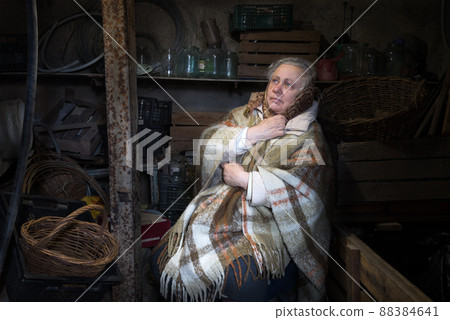 Frightened woman hide from explosions in the basement. During the sirens due to the shelling of Kyiv. Ukraine. 26 February 2022 Frightened woman hide from explosions in the basement. During the sirens due to the shelling of Kyiv. Ukraine. 26 February 2022 88384641