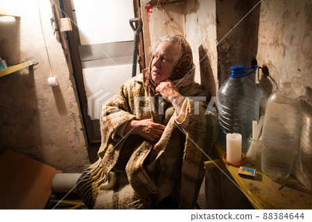 Frightened woman hide from explosions in the basement. During the sirens due to the shelling of Kyiv. Ukraine. 26 February 2022 Frightened woman hide from explosions in the basement. During the sirens due to the shelling of Kyiv. Ukraine. 26 February 2022 88384644