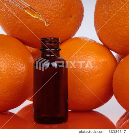 Orange essential oil in a small bottle Selective focus. Orange essential oil in a small bottle Selective focus. 88384847