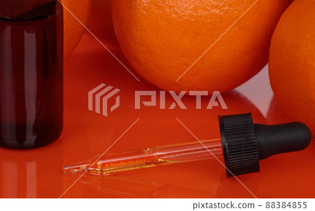 Orange background dropper, massage oil. Nature's relaxing properties. Orange background dropper, massage oil. Nature's relaxing properties. 88384855