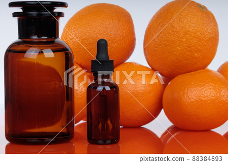 Medicine bottles on orange background, natural healing properties of citrus. Medicine bottles on orange background, natural healing properties of citrus. 88384893