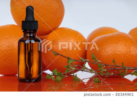 Bottle with essential oils, dropper with oil. Fresh oranges. A natural remedy for depression. 88384901