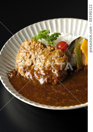 Photographed a coarse hamburger curry with stewed vegetables and parsley on a black background Photographed a coarse hamburger curry with stewed vegetables and parsley on a black background 88390122