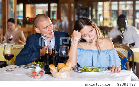 Unhappy couple quarreling during dinner at restaurant Unhappy couple quarreling during dinner at restaurant 88391488