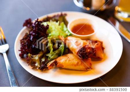 Fried spring rolls with vegetables and shrimps with sauce and salad 88391500