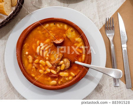 Fabada asturiana in brown soup plate 88391528