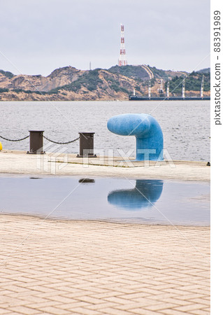 Bollard reflected in a puddle | Vertical composition 88391989