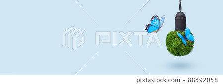 Green energy banner concept. Light bulb made from green plants with blue butterflies as symbol of pure nature without polluting waste 88392058