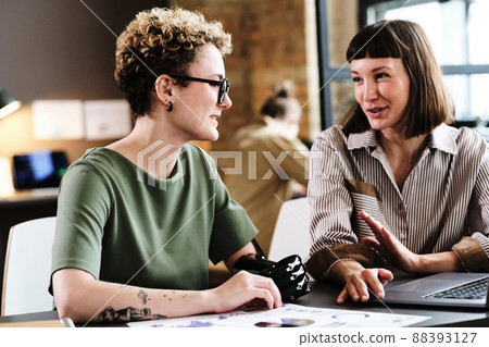 Girl with disability having business interview with businesswoman at the table with laptop 88393127